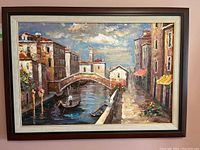 Full view of framed oil painting showing a Venice canal scene with gondolier, bridge, buildings, and water reflections.