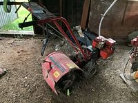 Side view showing entire tiller including front tines and rear wheels