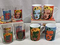 Set of four old fashioned glasses and four mugs in original boxes with Andy Warhol Marilyn Monroe artwork.