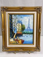 Full shot of framed painting with Eiffel Tower and Seine River scene.