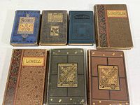 Seven 19th century poetry books arranged showing decorative covers and titles from Scott, Ingelow, Longfellow, Lowell, Tennyson, Whittier, Arlington Edition.