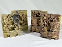 Two pairs of hand-carved Chinese soapstone bookends in brown and maroon shade, showing front view of all four pieces.