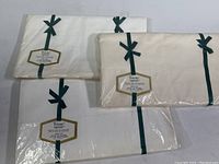 Three packages of vintage Wamsutta Supercale twin flat sheets and pillowcases, all sealed with green ribbons and labeled packaging.