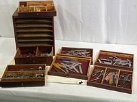 Overall view of the chest and its seven drawers opened showing various small tools and fittings inside.