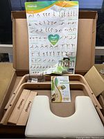 FeetUp yoga headstand shelf components including wooden frame, cushion, blocks, manual, and hardware inside box.