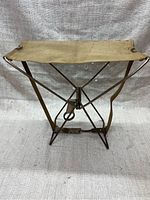 Front view of folding army chair showing canvas seat and metal support frame.