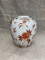 Front side of the vase showcasing the red floral and gold leaf design