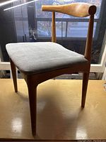 Single chair showing front three-quarter view, curved backrest and suede seat