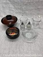 Photo of all items together showing lacquerware bowls, glass cornflower cups, salt and pepper shakers, and candy bowl