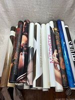 Rolled movie posters stacked side by side showing visible titles and rolled edges.