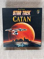 Closed view of Star Trek Catan game box with cover artwork showing Star Trek starship and planet.