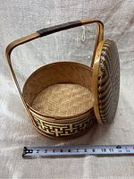 Open basket showing woven interior and measuring tape for size reference.