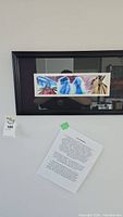 Full view of framed original Jerry Whitehead art on wall with typed description below it