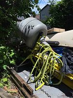 Full assembly showing drum, frame, wheels, and hose coiled on mixer