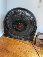 Honeywell floor fan showing black plastic blades and grill with dust and cobwebs