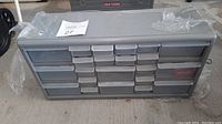 Closed view of gray plastic hardware organizer with 22 drawers