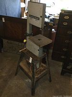 Full view of the Rockwell Beaver 10 bandsaw showing the machine on a stand with the worktable and safety guard visible.