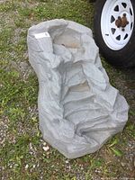 Front angle showing tiers and cascading water channels to simulate a waterfall effect with stone-like resin construction.