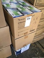 Photo showing a full case of Pri-Med branded nitrile examination gloves in boxes, stacked with visible labels and size Medium marked.
