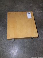 Closed wooden case with metal latches on concrete floor