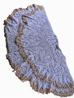 Doily folded with visible mauve crochet and frayed taupe edging.