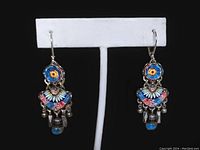 Front view of the pair of Ayla Bar hand crafted dangle earrings displayed on white stand against black background.