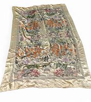 Full view of vintage Asian oriental brocade tapestry with gold background and colorful embroidery.