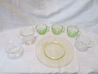 Full set of 7 items including creamer, dinner plate, cups, sugar bowl, and sherbet served on a white background