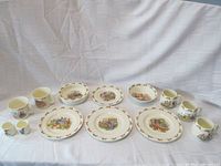 Full set of Royal Doulton Bunnykins porcelain items arranged on white sheet showing all pieces together.