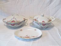 Three piece set with two covered serving dishes and one oval platter featuring pink and yellow floral designs.