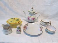 Full set of 7 Nippon porcelain items showing teapot, teacup, saucer, creamer, condiment shaker, covered serving dish, salad plate, and footed bowl