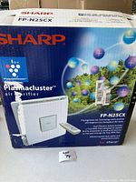 Box of Sharp Plasmacluster FP-N25CX air purifier showing front and model details, including Plasmacluster technology logo