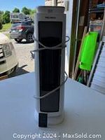 Front view of the white Pelonis air purifier with power cord wrapped around it.