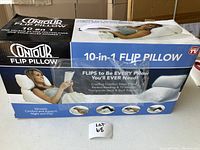 Photo of the boxed Contour Flip Pillow showing the product name, 10-in-1 flip design, and usage images.
