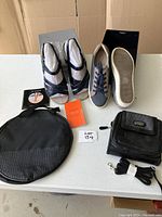Complete lot with two pairs of shoes including Vionic Mirabi leather sandals and Alexander Smith sneakers plus two black carry bags and accessories.