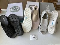 Three pairs of Bzees shoes displayed with boxes, including pink slip-ons, black sandals, and white cloth sandals.
