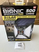 Box of Bell & Howell Bionic Spotlight Trio solar powered spotlight showing front with product name, key features like 500 lumens, no batteries or wires, multi-directional LED, and motion activation.