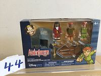 Front of the Disney Adventures Peter Pan Mega Minis 16-piece action pack in sealed box, showing three mini figures and accessories.