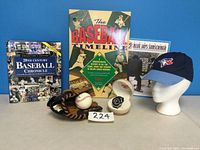 Full lot display with books, baseball, glove, cap, and clock