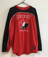 Front view of Canada hockey jersey in red and black with logo.
