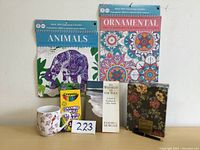 Lot contents showing all included items: two coloring calendars, mug, colored pencils, book and stationary set.