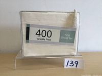 Front view of packaged cream colored microfiber king sheet set with label showing 400 thread count, wrinkle free and king sheet set text.