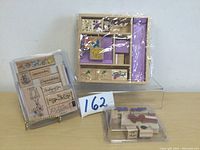 Wooden and rubber stamps collection displayed together with packaging visible