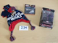 Photo of Star Wars hat and gloves with a Star Wars Micro Machines toy set and Marvel Legends Hawkeye figures in packaging