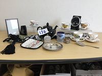 View of entire tea set and accessories arranged on table