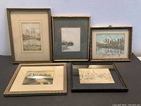 Five small framed paintings shown together on a flat surface. Various landscape and nature scenes. Used condition with visible wear on frames and matting.