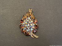 Front view of large vintage brooch showing design and colors