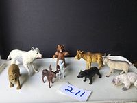 Full set of nine Canadian wildlife rubber animal figurines arranged on a white surface with black background.