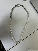 Full view of the Vitaly Akoya necklace showing the transition from synthetic pearl beads to stainless steel ball chain and the clasp closed.