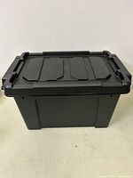 Single black stackable storage bin with secure locking lid, showing design and structure.